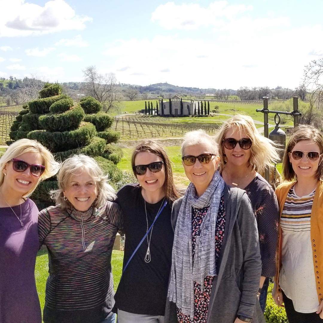 Group of women in from of vineyard